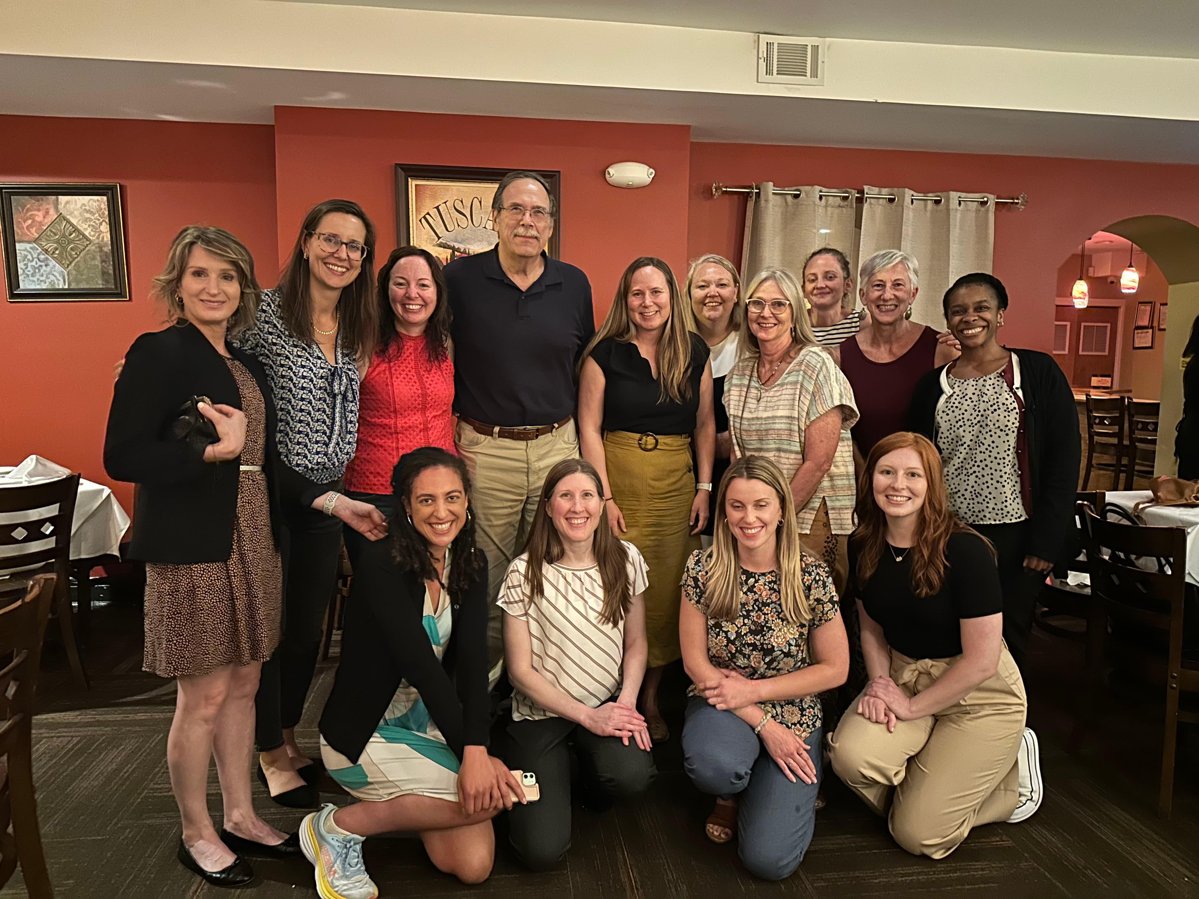 Dr. Farrell surrounded by previous students