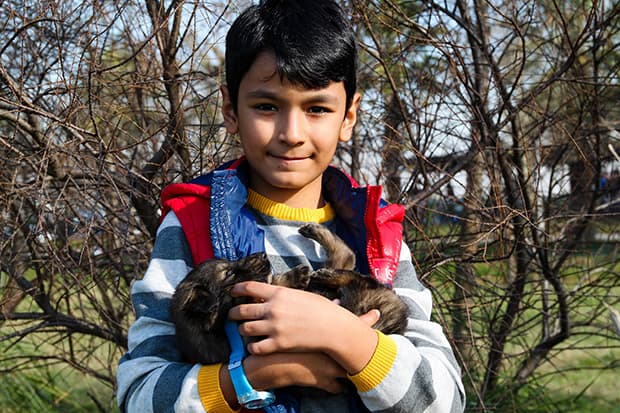 young boy holds puppy