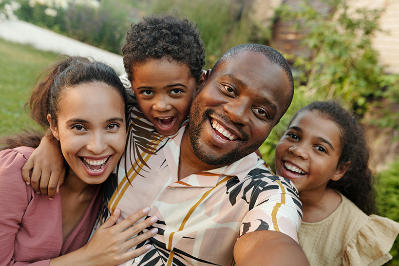 Two adults and two children pose for a selfie