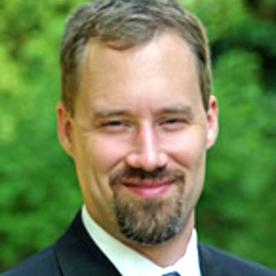 Bryce McLeod, Ph.D., in front of greenery