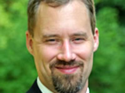 Bryce McLeod, Ph.D., in front of greenery